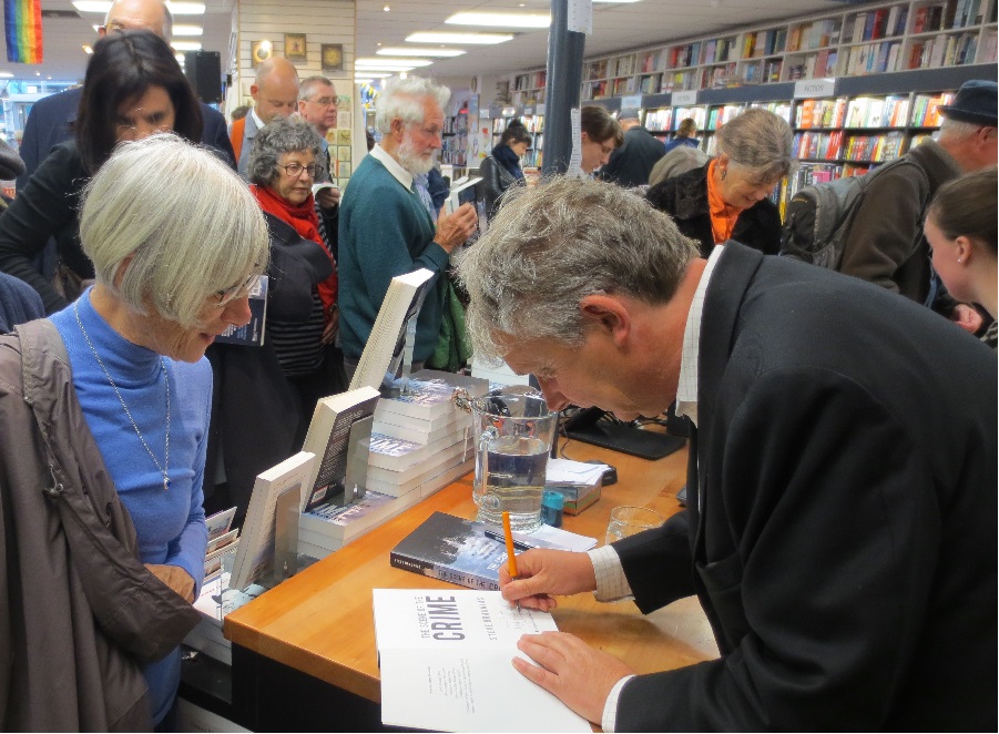 Steve signing copies of his book.